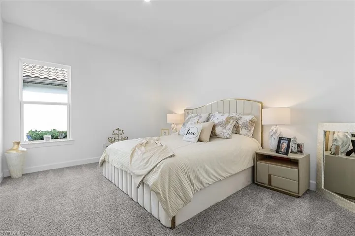 Carpeted bedroom featuring baseboards
