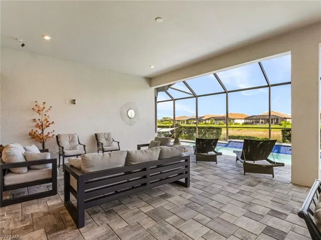 View of patio with outdoor lounge area, an outdoor pool, glass enclosure, and a residential view