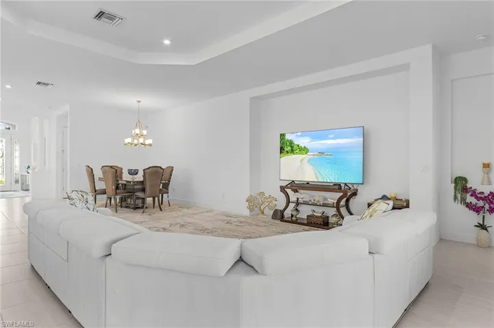 Living room featuring a chandelier, recessed lighting, and light tile patterned floors