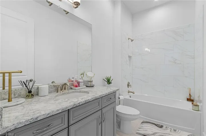 Bathroom featuring vanity and bathtub / shower combination