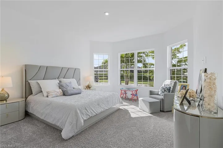 Bedroom with carpet flooring and multiple windows