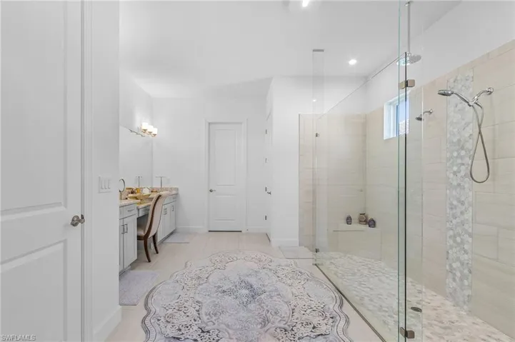 Bathroom featuring vanity and a stall shower