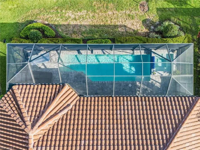 View of swimming pool with a lanai