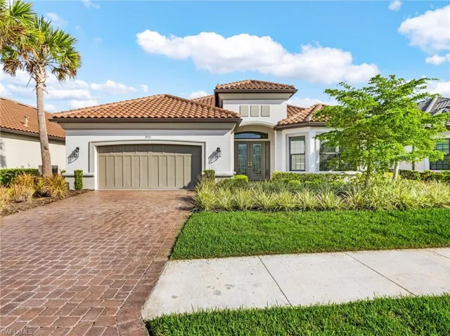 Mediterranean / spanish-style home featuring french doors, decorative driveway, an attached garage, stucco siding, and a tile roof