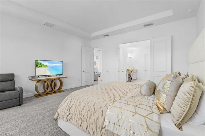 Bedroom featuring carpet flooring and baseboards
