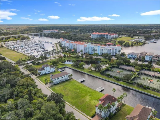 Aerial perspective showcasing a marina, waterway, and surrounding properties