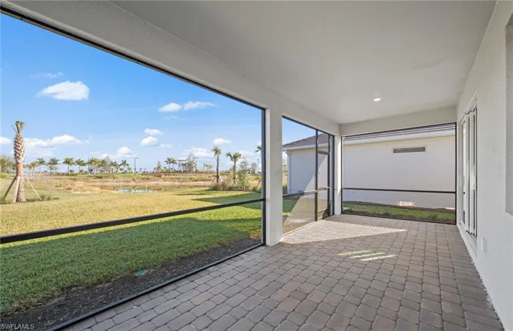 Unfurnished sunroom featuring a water view