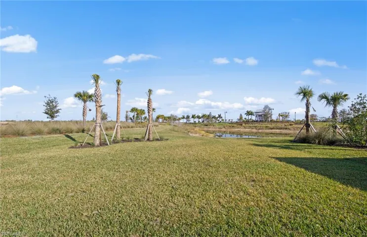 View of green lawn featuring a water view