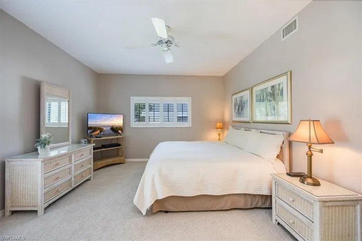 Bedroom featuring light colored carpet and ceiling fan