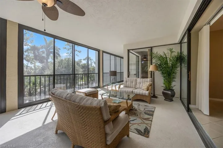 Sunroom featuring ceiling fan