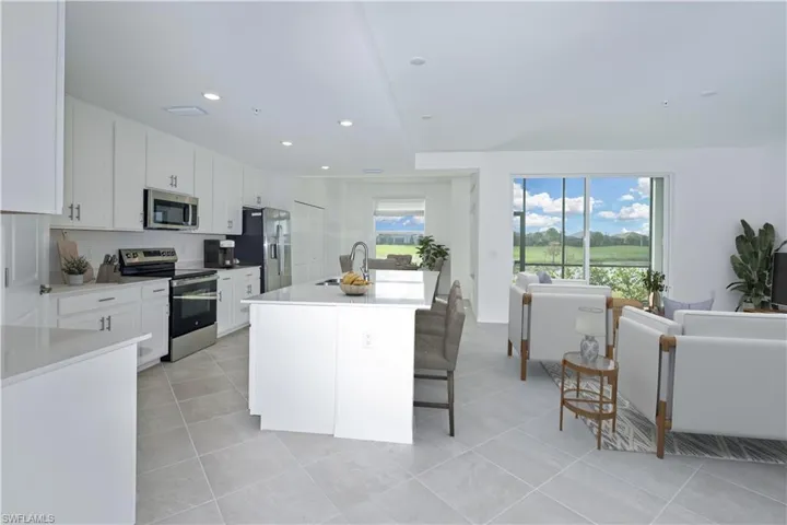 Virtually staged kitchen and living areas.