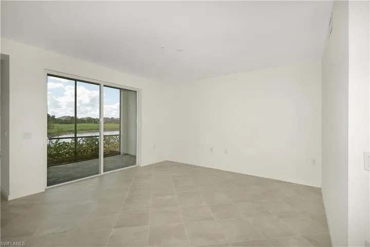 Living room with lake and golf course view.
