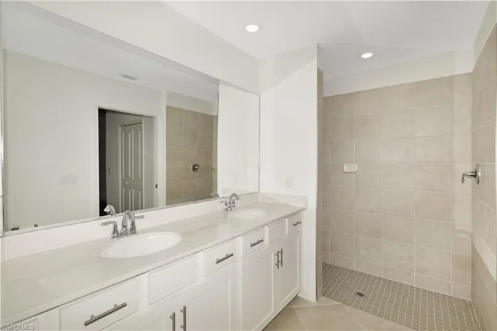 Master bath with dual sinks and large walk-in shower.