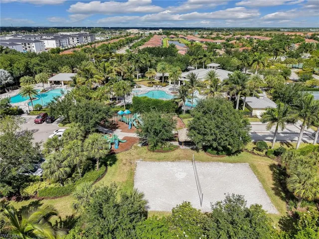 Expansive community amenities including multiple swimming pools, a sand volleyball court, and a dedicated playground area