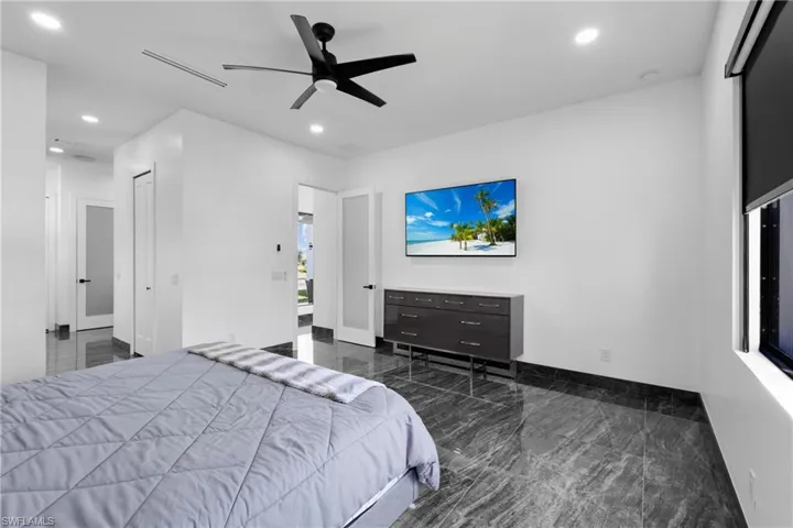 Bedroom featuring marble tiled floors, recessed lighting, baseboards, and ceiling fan