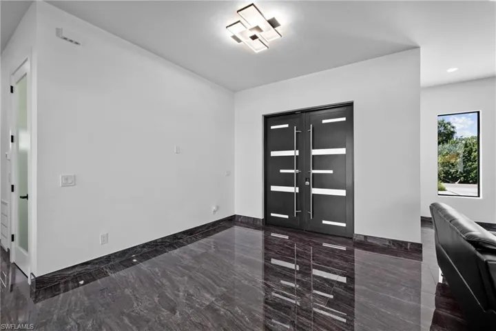 Foyer entrance featuring marble tiled flooring, recessed lighting, and baseboards