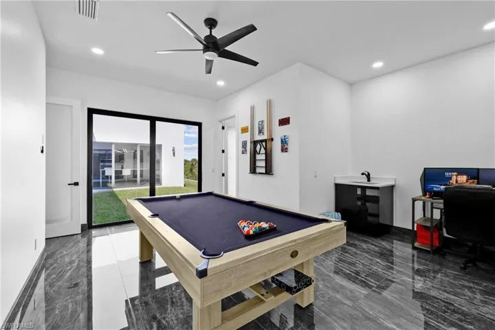 Game room with billiards, ceiling fan, recessed lighting, and marble finish floors