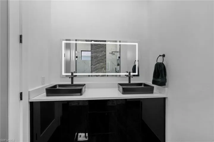Full bathroom with a shower stall and double vanity