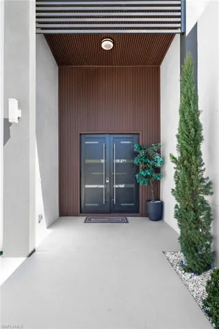 Entrance to property with stucco siding