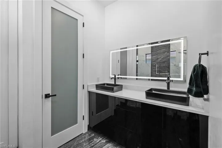 Full bathroom with a stall shower and double vanity