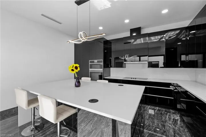 Kitchen featuring dark cabinetry, modern cabinets, stainless steel double oven, black electric stovetop, and recessed lighting
