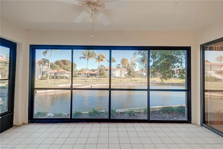 Unfurnished sunroom featuring a water view, healthy amount of natural light, and tile patterned flooring