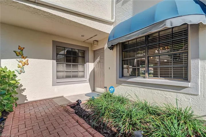 Doorway to property with stucco siding
