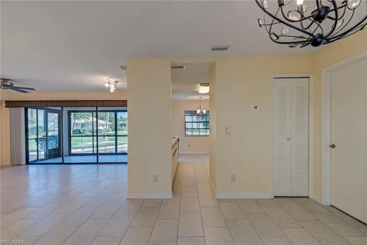 Empty room with a chandelier and ceiling fan