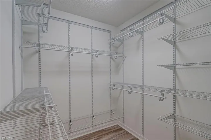 Spacious closet with light wood-type flooring