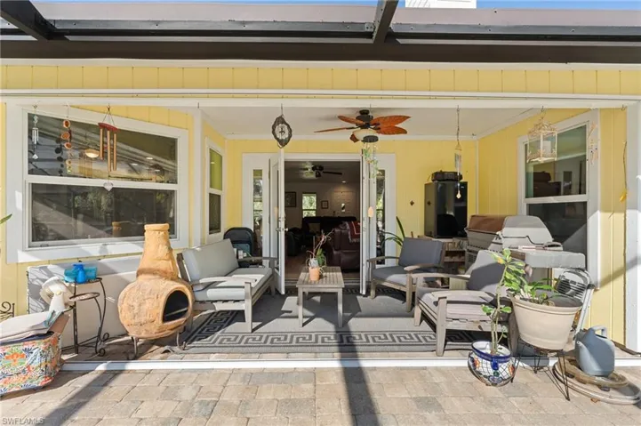 View of patio with an outdoor hangout area and ceiling fan