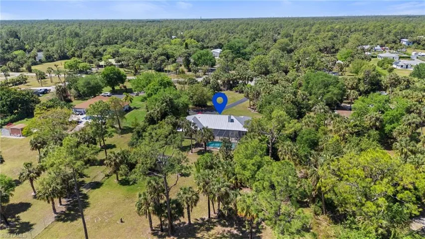 Birds eye view of property with a forest view