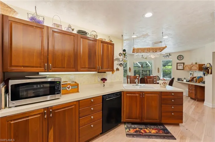 Dining room featuring light wood-style flooring, a ceiling fan, visible vents, and baseboards