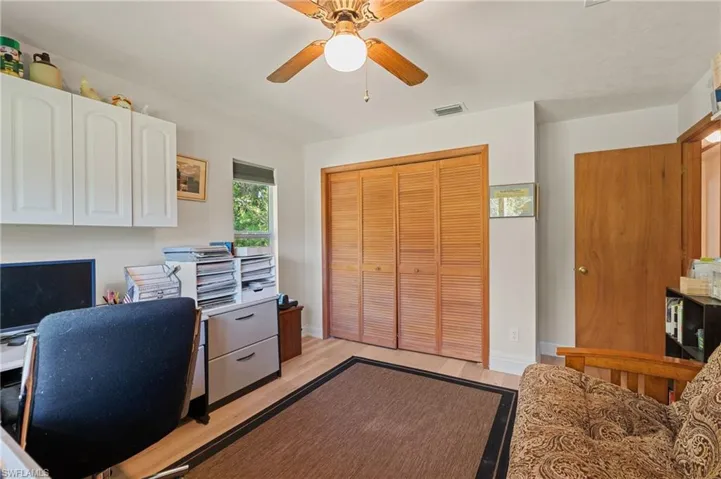 Office featuring a ceiling fan, light wood-style floors, and baseboards