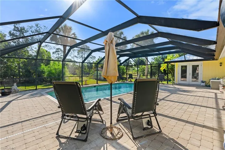 Outdoor pool featuring a patio and a lanai
