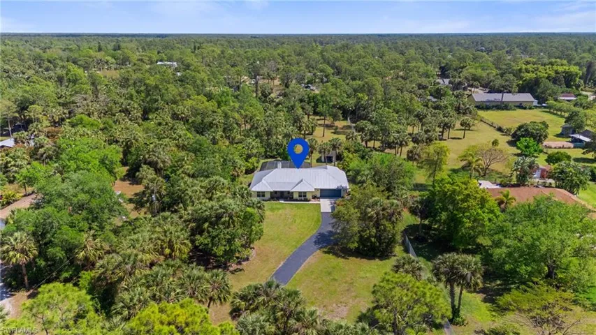 Aerial view featuring a forest view