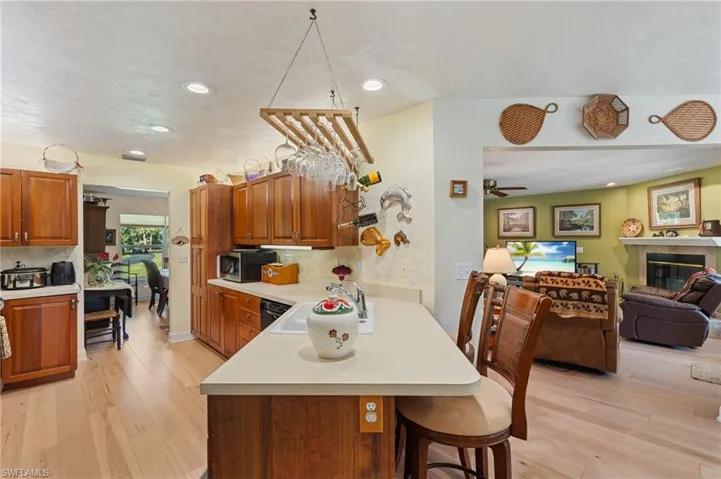 Living room featuring baseboards, visible vents, ceiling fan, light wood-style floors, and french doors