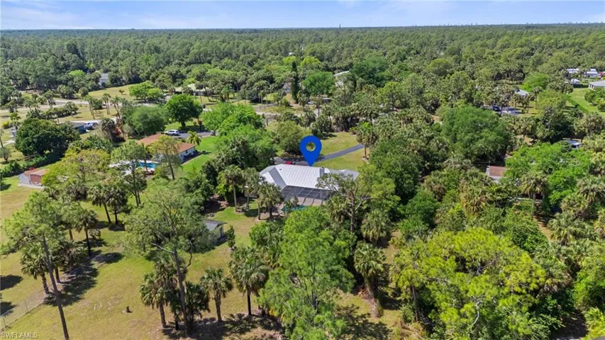 Birds eye view of property with a view of trees