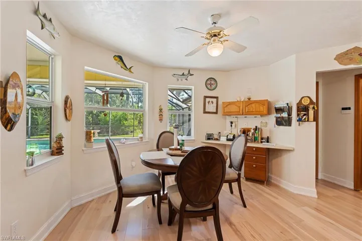 Dining room with recessed lighting, light wood-style floors, baseboards, and a notable chandelier