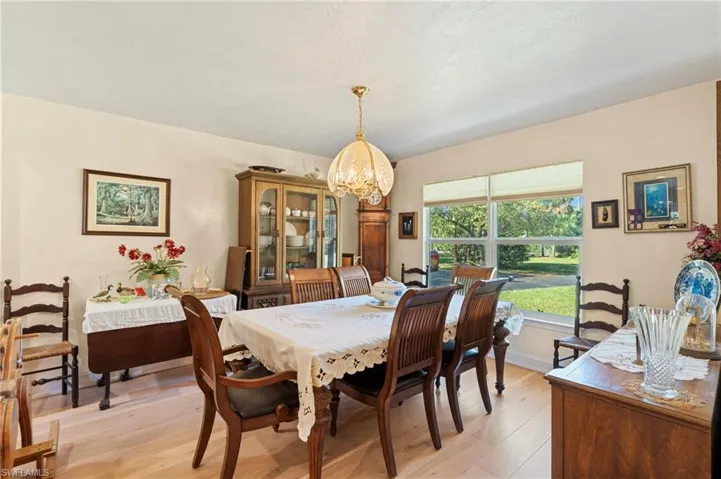 Office featuring light wood-style flooring, baseboards, visible vents, and ceiling fan