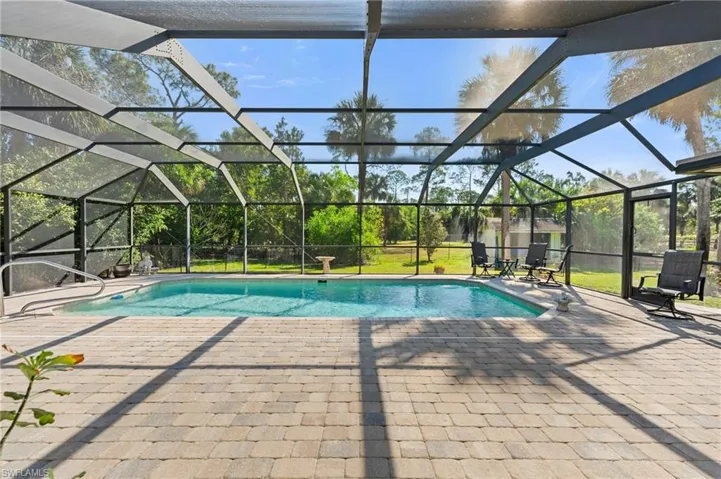 Pool with french doors, a lanai, and a patio area