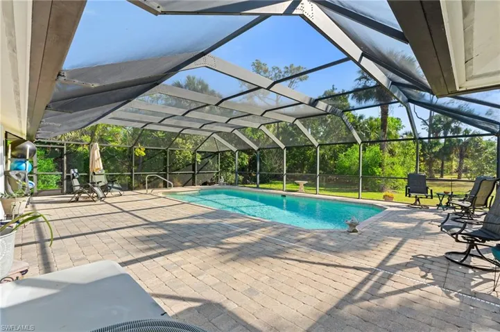 Outdoor pool with french doors, a patio, and glass enclosure