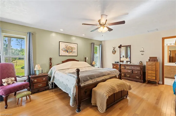 Bathroom with a closet, a shower stall, and a garden tub