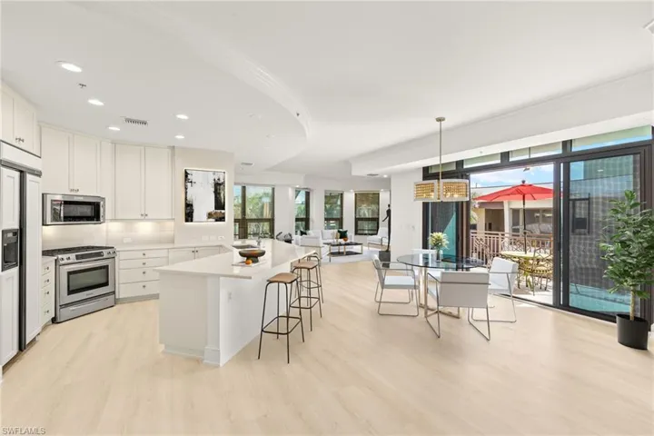 Kitchen with a breakfast bar, a wealth of natural light, visible vents, and appliances with stainless steel finishes