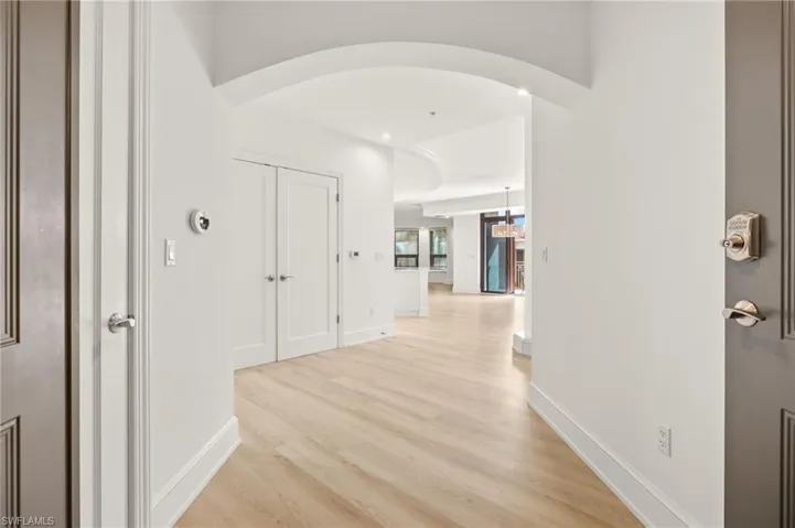 Corridor featuring baseboards and light wood-style flooring