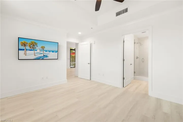 Unfurnished bedroom featuring visible vents, crown molding, baseboards, recessed lighting, and light wood-type flooring