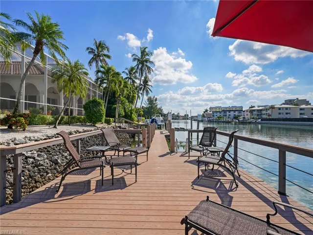 Dock area featuring a deck with water view and a lanai