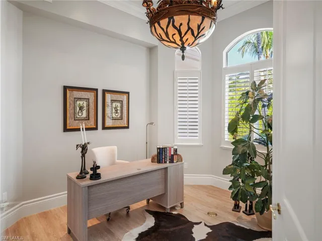 Office space featuring light wood-type flooring and ornamental molding
