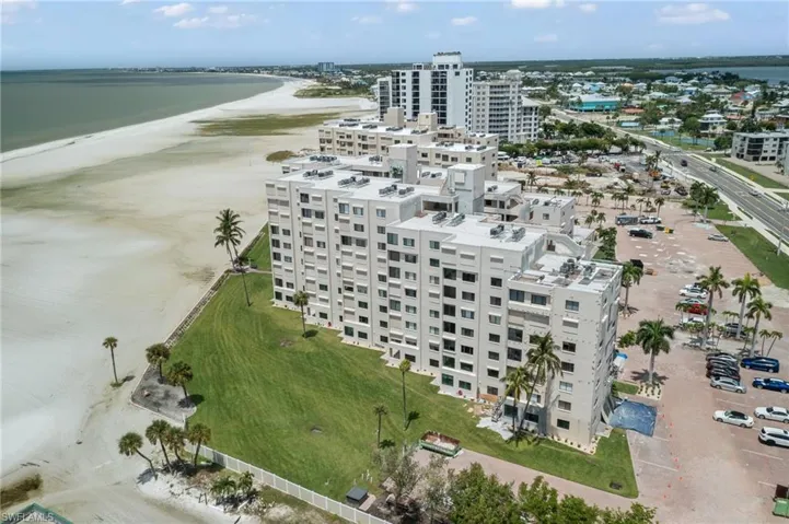 Aerial view featuring a beach view and a water view