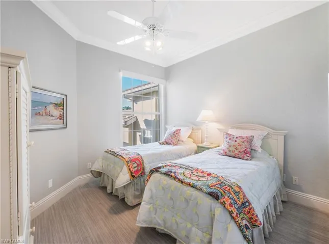 Guest 2 Bedroom with crown molding, ceiling fan, and carpet