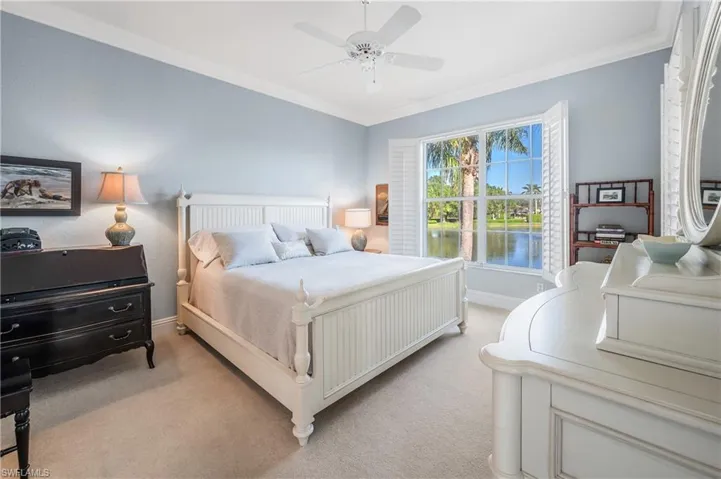 Master Bedroom featuring light carpet, plantation shutters, crown molding, and ceiling fan
